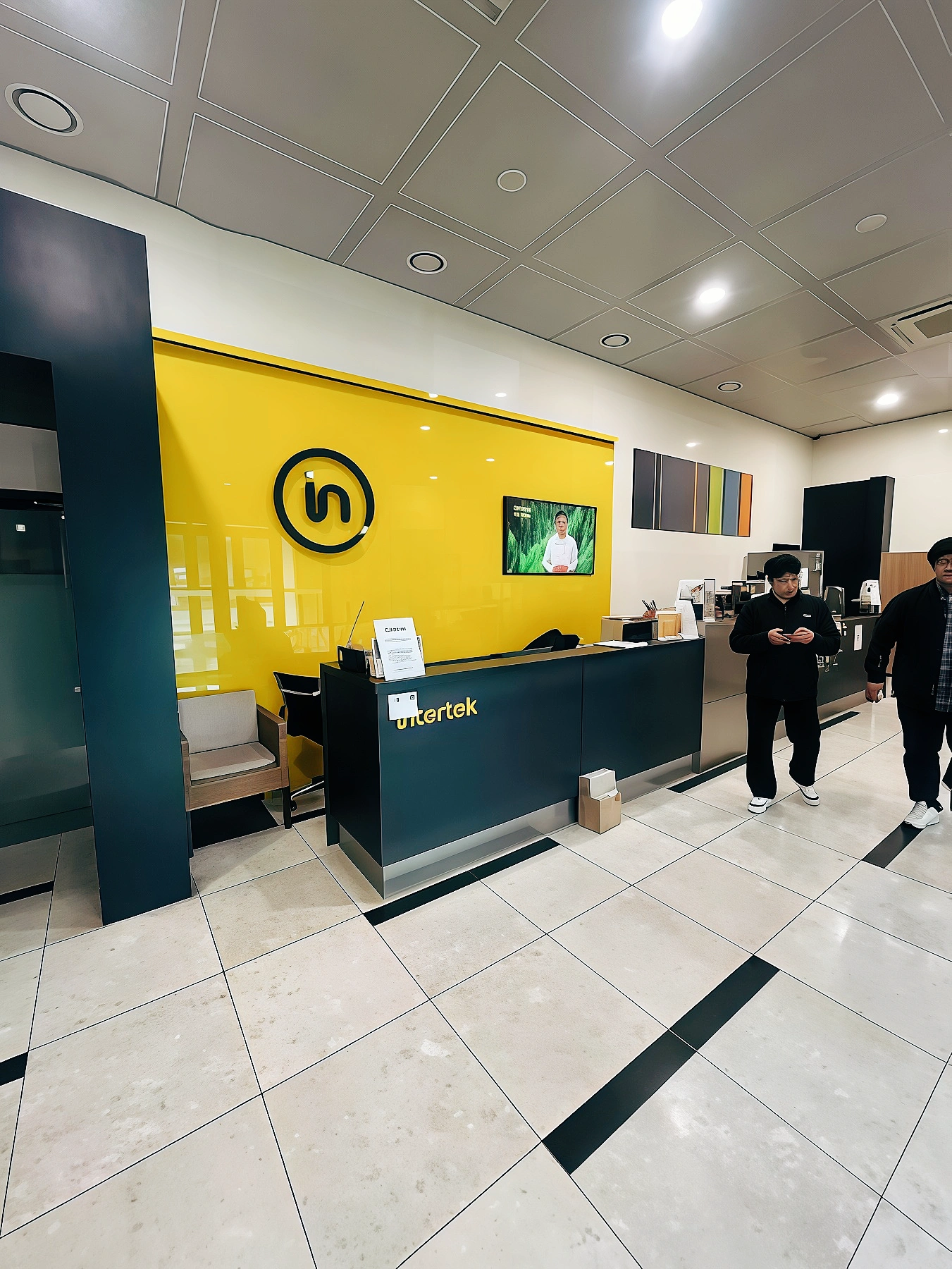 KingPo Intertek IEC 60335 test equipment delivery - Intertek Korea laboratory reception desk with yellow branding wall and staff members