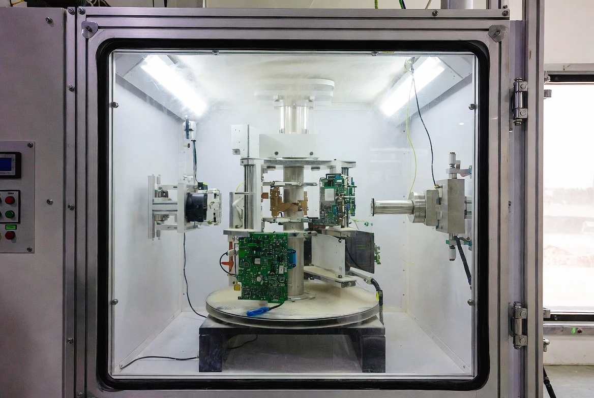 KingPo Sand and Dust Test Chamber during active testing with automotive parts inside.