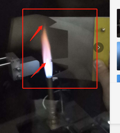 Real 500W flame during testing with clear inner blue cone and outer flame, highlighted with red arrows