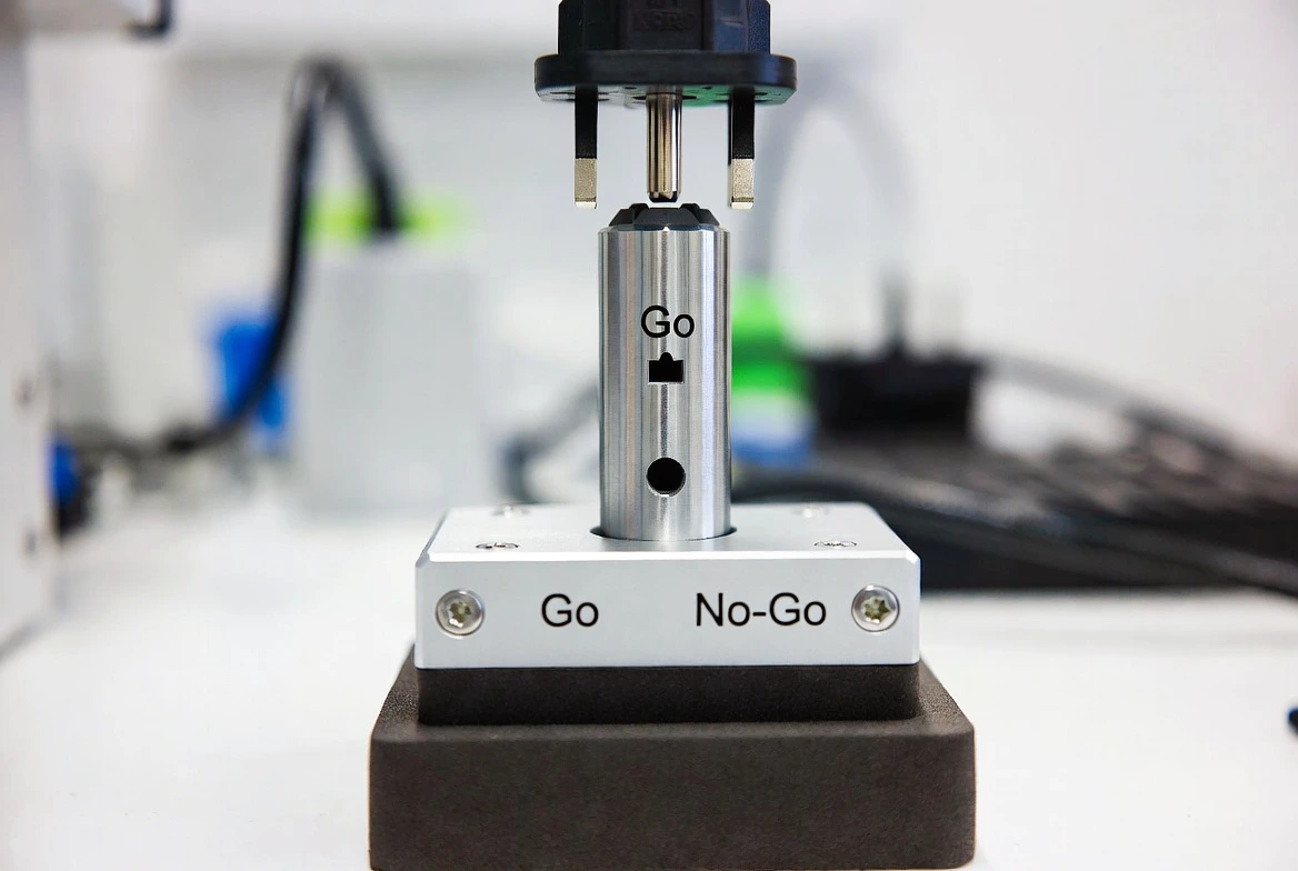 Close-up of KingPo Go/No-Go Socket Plug Gauge testing electrical plug.