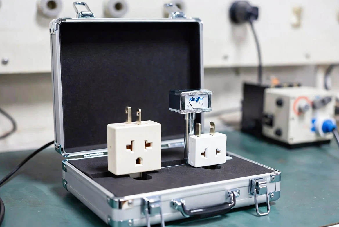 KingPo Socket Plug Gauge performing compliance test on electrical outlet and plug.
