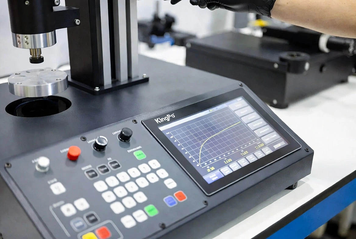 Close-up of KingPo tensile strength testing machine touchscreen and real-time stress-strain curve display.