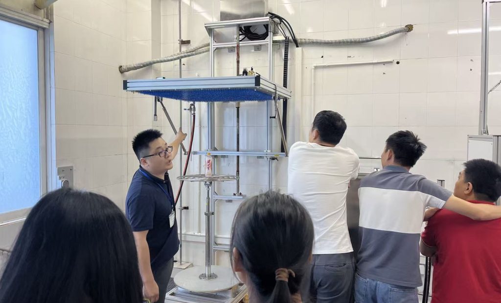 IPX3 IPX4 oscillating tube rain test system demonstration in laboratory showing engineers operating IEC 60529 waterproof testing equipment KINGPO