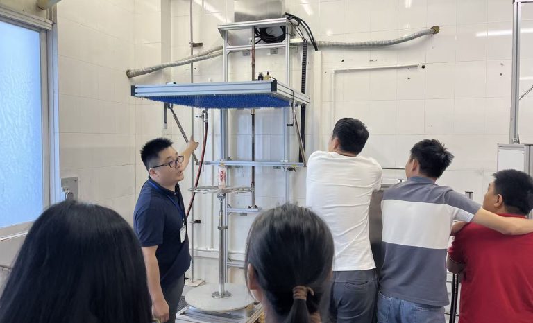 IPX3 IPX4 oscillating tube rain test system demonstration in laboratory showing engineers operating IEC 60529 waterproof testing equipment KINGPO