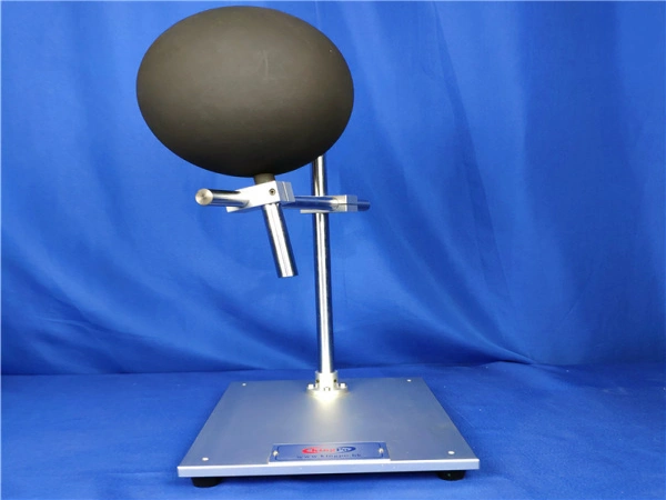 IEC 60335-2-23 wooden sphere mounted on a laboratory fixture for helmet-type hairdryer testing.