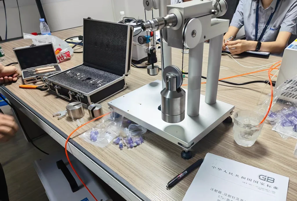 Vincent Visits KingPo for ISO 80369 Luer Connector Test Technical Exchange 2 Close-up of an ISO 80369 Luer connector test fixture and reference components during a technical demonstration at KingPo.