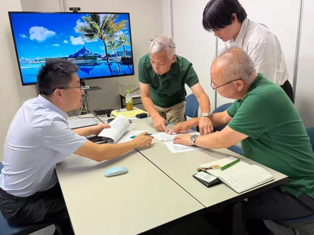 KingPo and Techno Science Japan representatives reviewing testing equipment requirements