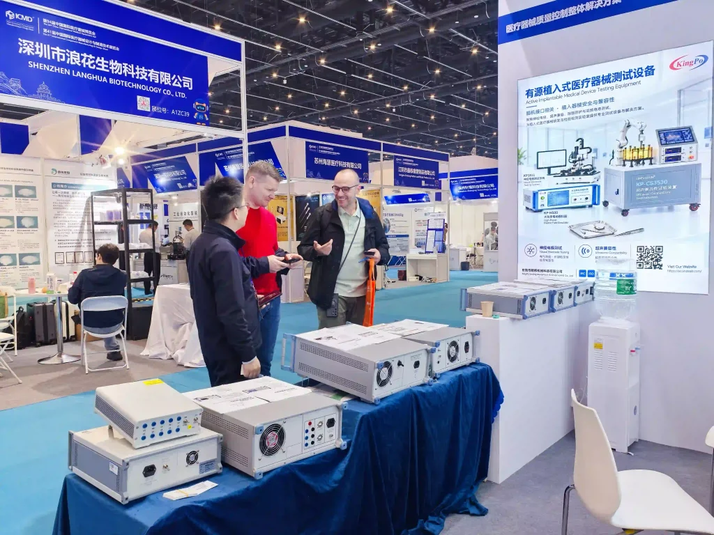 KINGPO Presents an Integrated Testing Solution for Implantable Brain-Computer Interfaces at CMEF 2026 4 Exhibition visitors discussing KINGPO active implantable medical device testing equipment at the CMEF 2026 exhibition booth